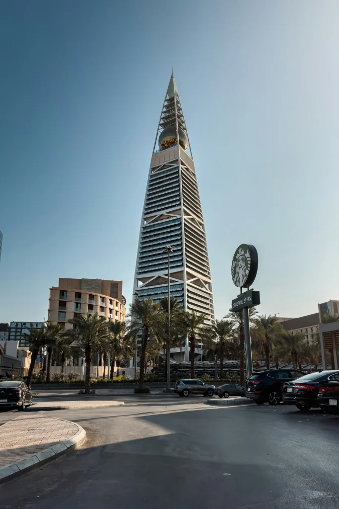 Al Faisaliah Tower with its golden globe above palm-lined streets