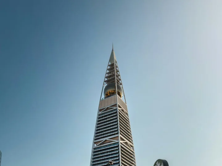 Al Faisaliah Tower with its golden globe above palm-lined streets