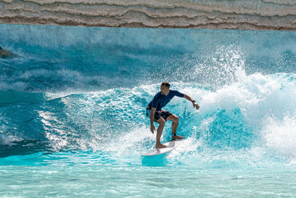 A surfer riding a wave at Aquarabia in Qiddiya City