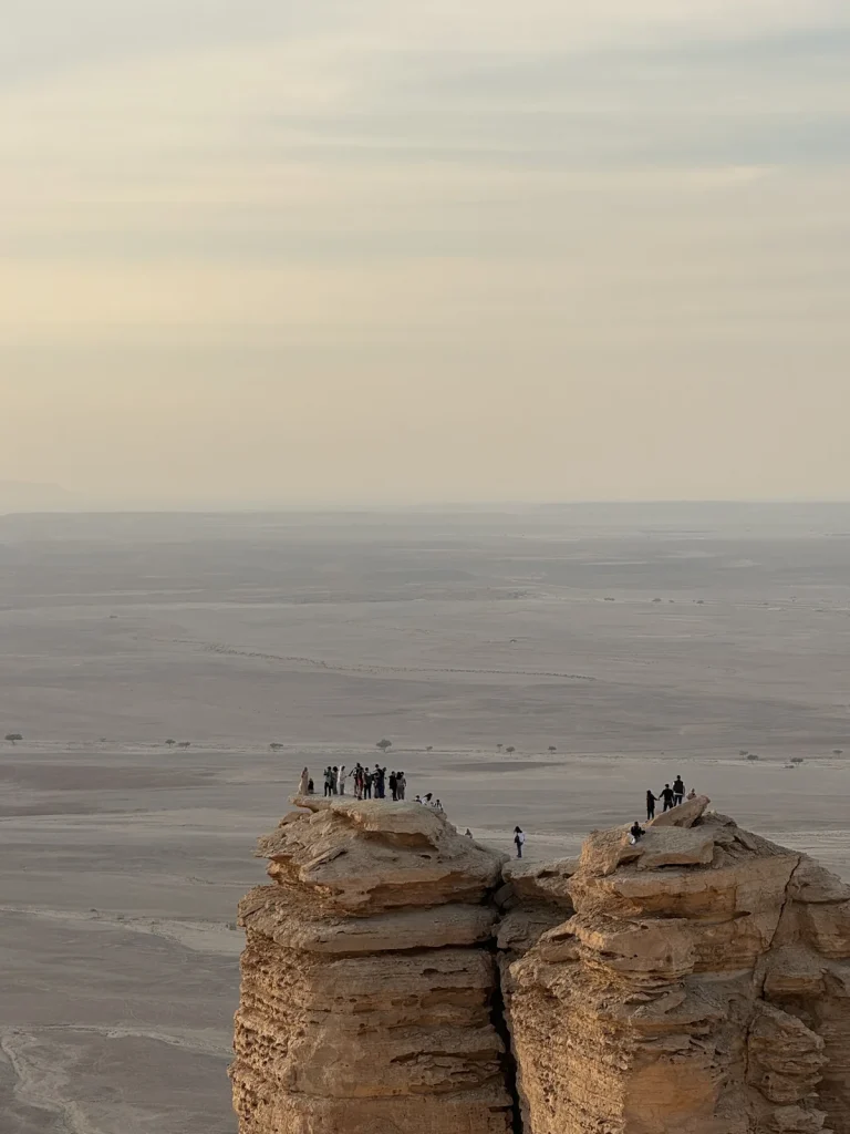 Visitors on a rocky escarpment at Edge of the World
