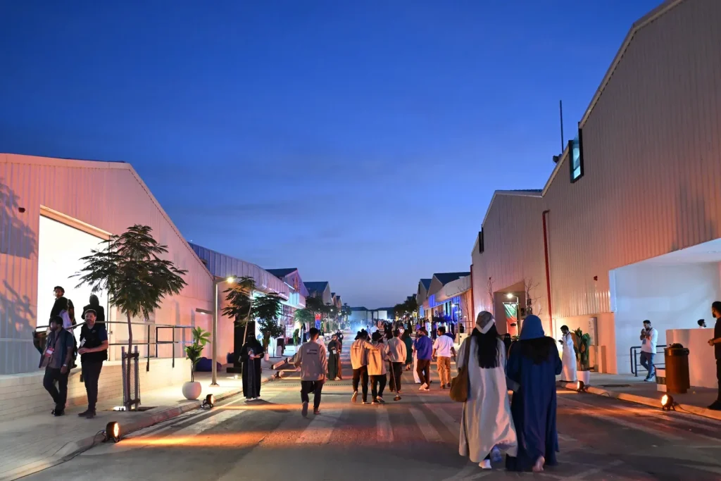 Visitors walking between converted buildings in JAX District