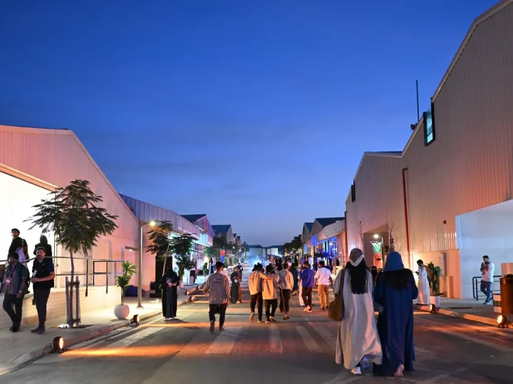 Visitors walking between converted buildings in JAX District