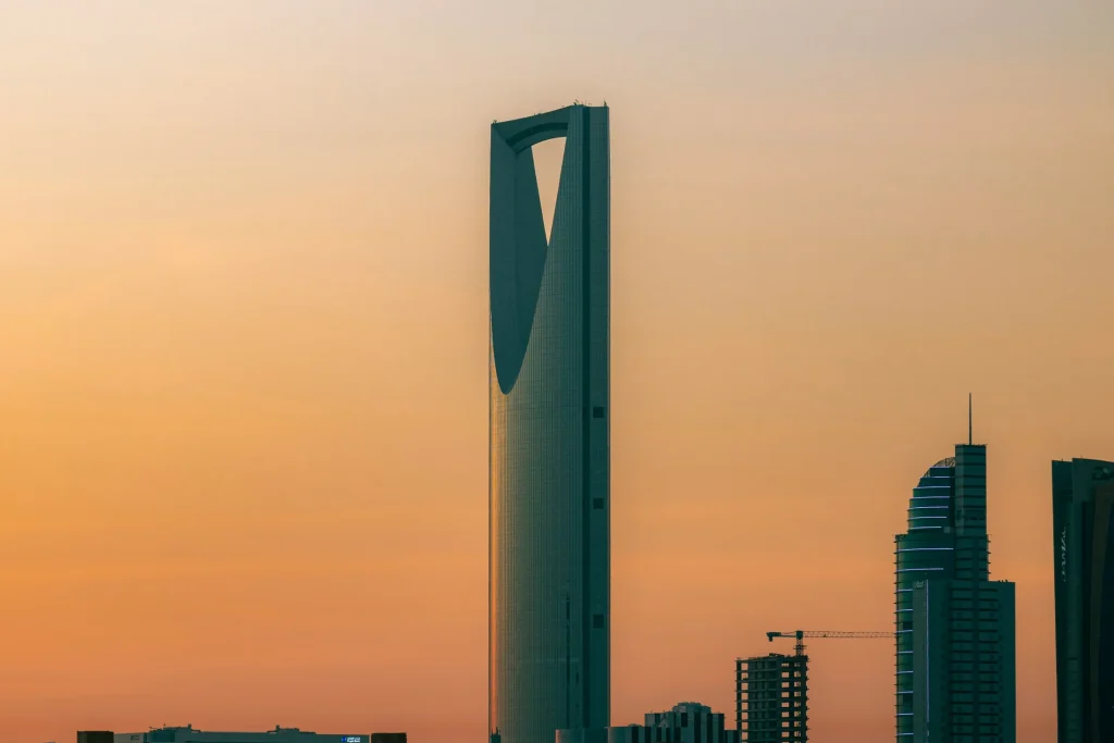 Kingdom Centre and nearby buildings against a golden sky