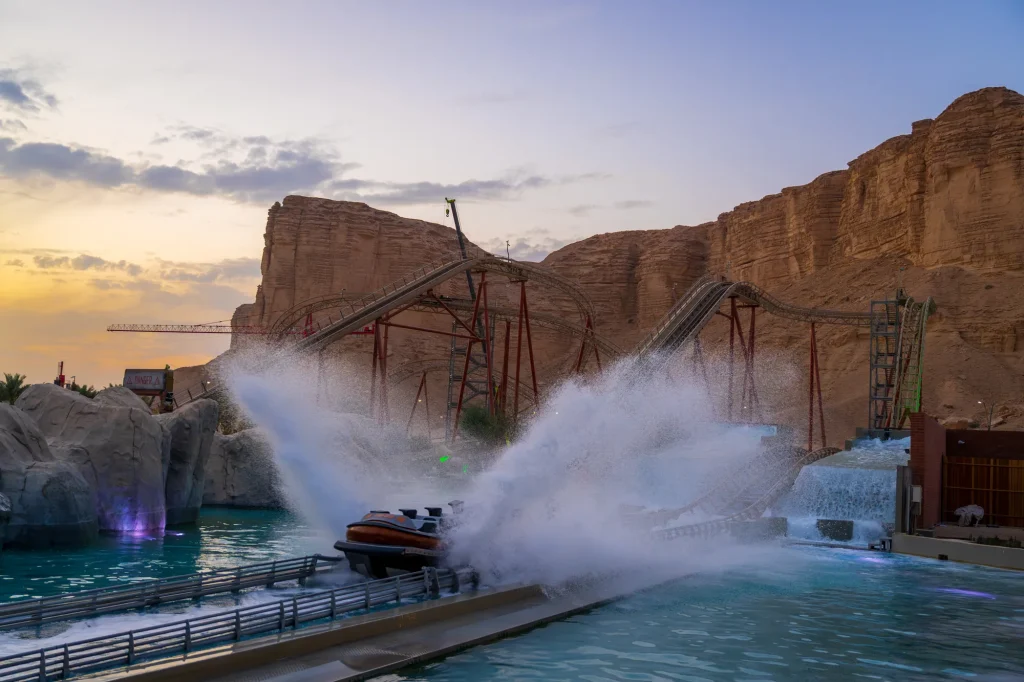 A water ride beside the cliffs at Six Flags Qiddiya City